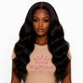 Natural Black 13x4 Body Wave Lace Front Human Hair Wig front view on a dark chocolate model wearing a beige WigMatch EU t-shirt. Soft body wave texture with a natural hairline and realistic middle part, wigmatch EU
