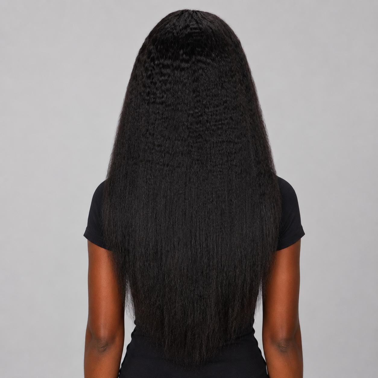 Back view of a 13x4 Kinky Straight Lace Frontal Human Hair Wig on a dark chocolate skin tone model, displaying the full density, long kinky straight texture, and natural finish. WigMatch EU – Free Shipping Across Europe.