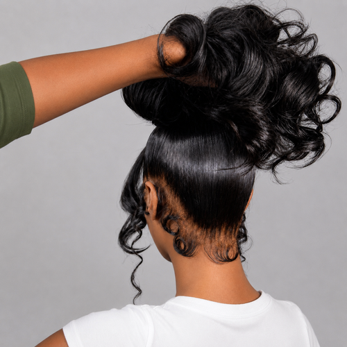 Back view of a dark-skinned model lifting a 360 Full Lace Wavy Human Hair Wig to showcase the smooth texture, natural movement, and full coverage.