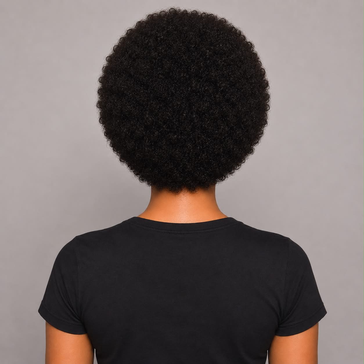 Woman showcasing the back view of the WigMatch Afro Kinky Curly Human Hair Wig with soft natural curls, shop online with fast free shipping across the European Union.