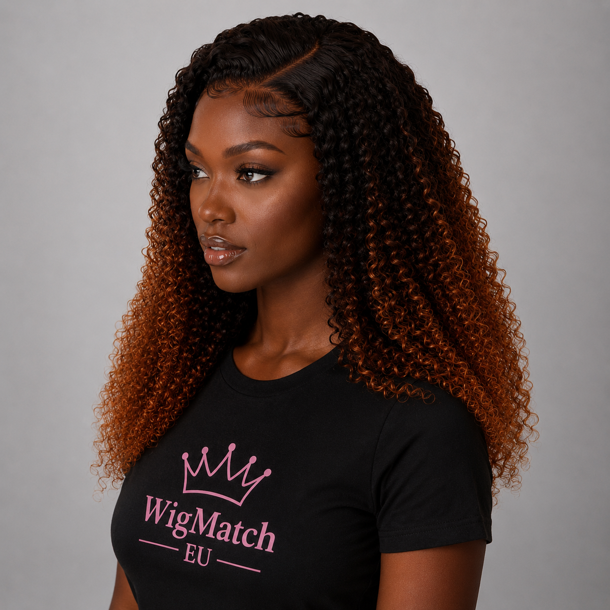 Side view of a dark chocolate model wearing an ombre kinky curly human hair wig with defined tight curls, natural hairline, and realistic baby hairs.