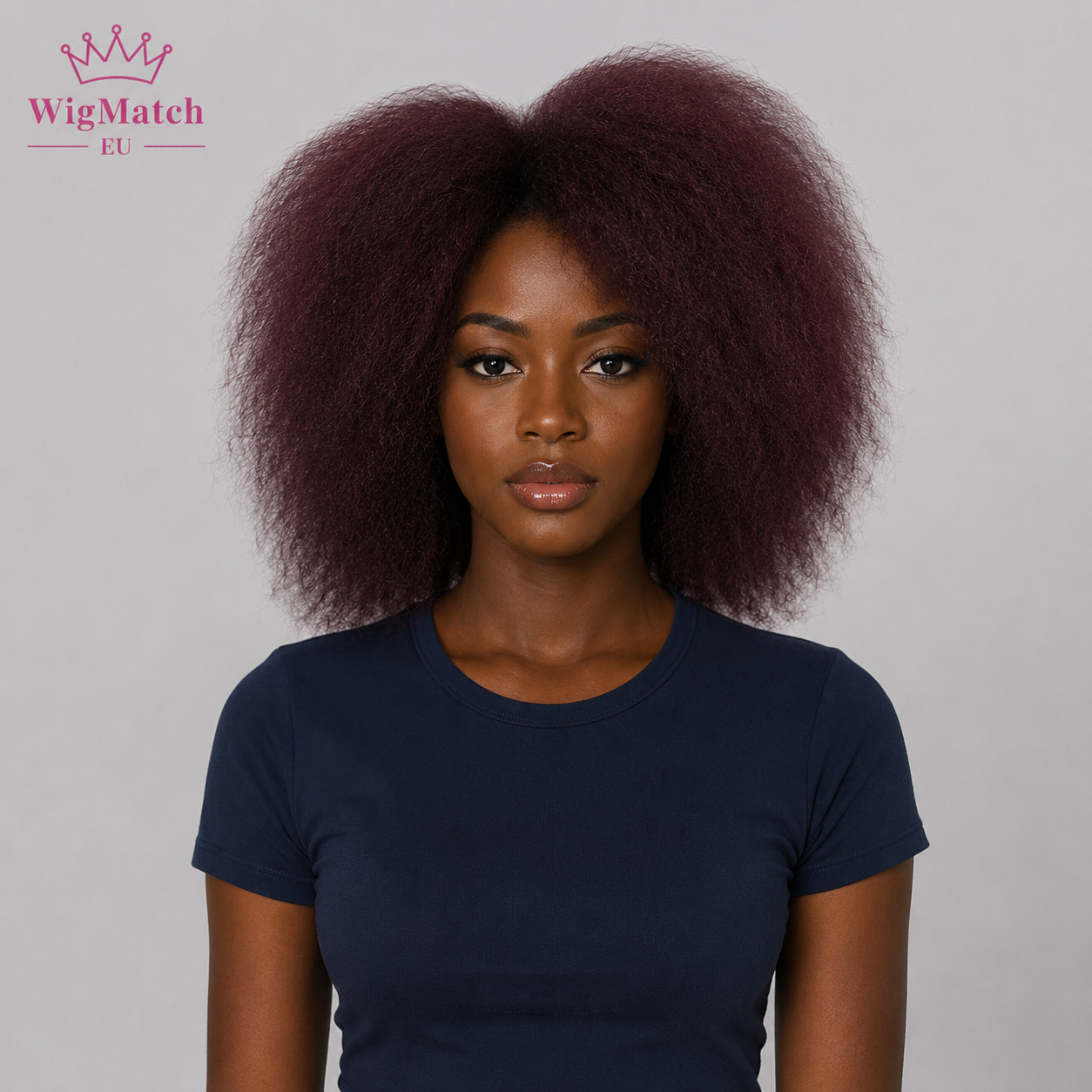 Model wearing a natural afro kinky curly wig in burgundy 99J, front view, dark chocolate skin, WigMatch EU.