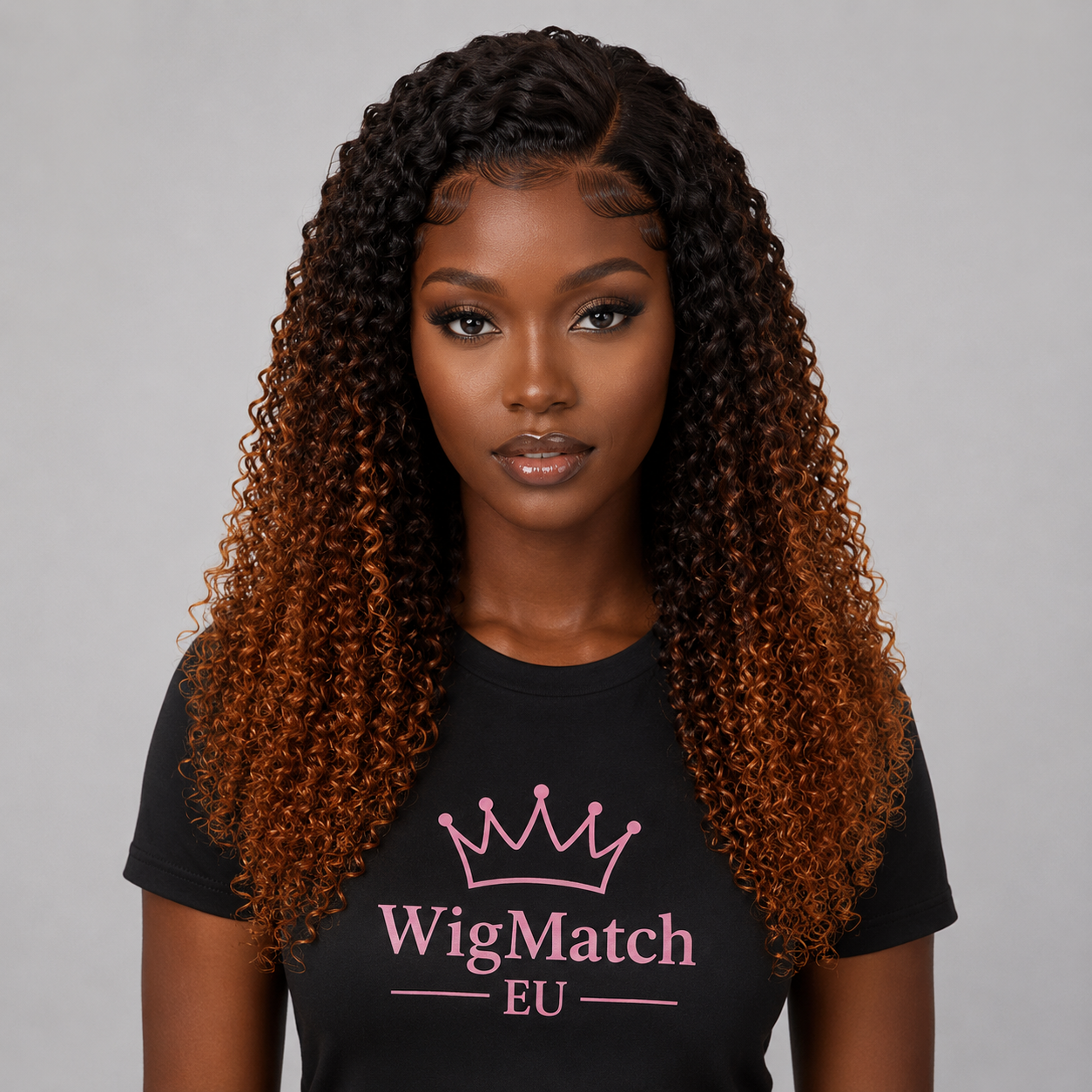 Front view of a dark chocolate model wearing an ombre kinky curly human hair wig with defined kinky curls, natural-looking hairline, neatly styled baby hairs, and a middle part.