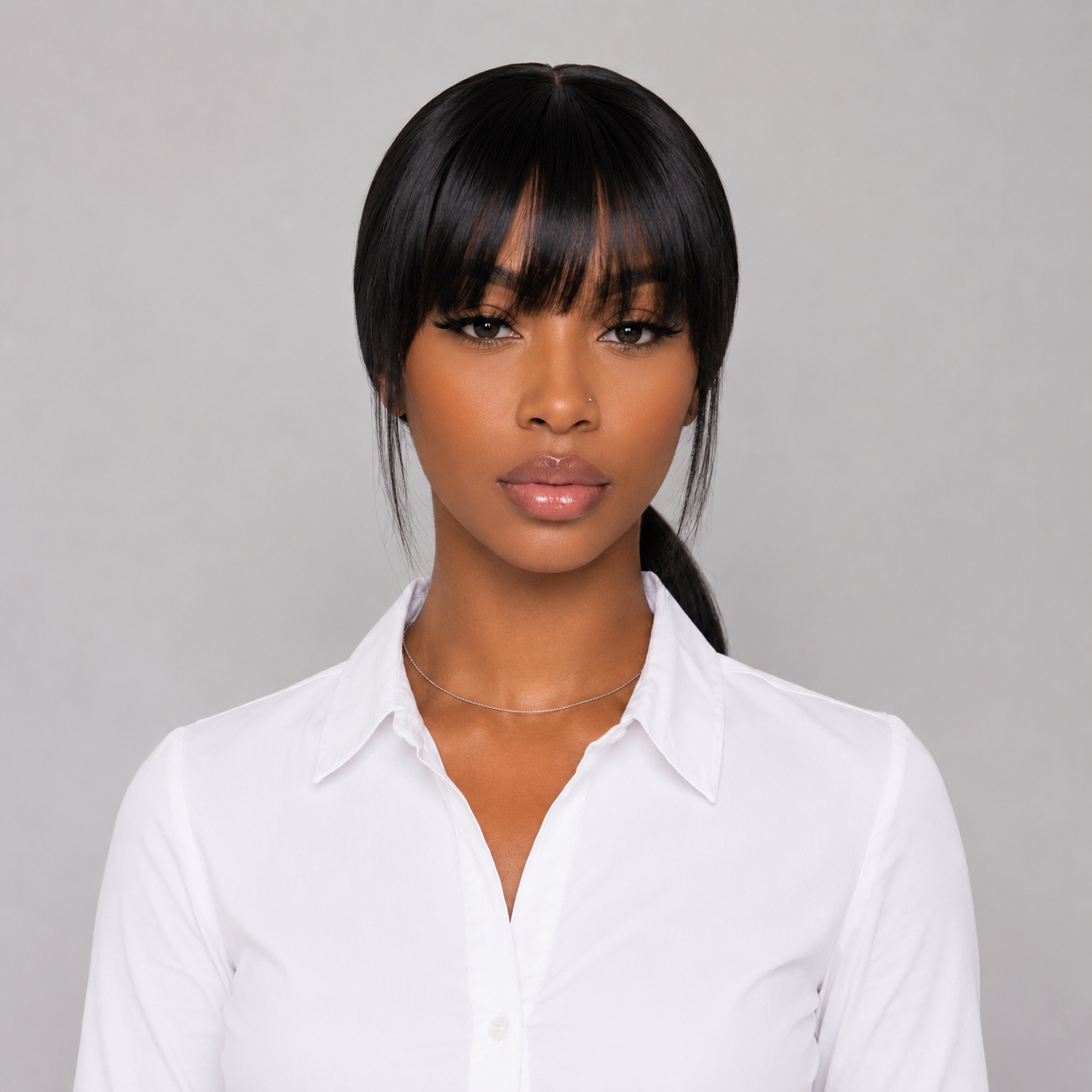 Model front view showcasing the WigMatch EU Long Straight Human Hair Wig with Full Bangs in Natural Black, featuring smooth straight hair with a soft full fringe.