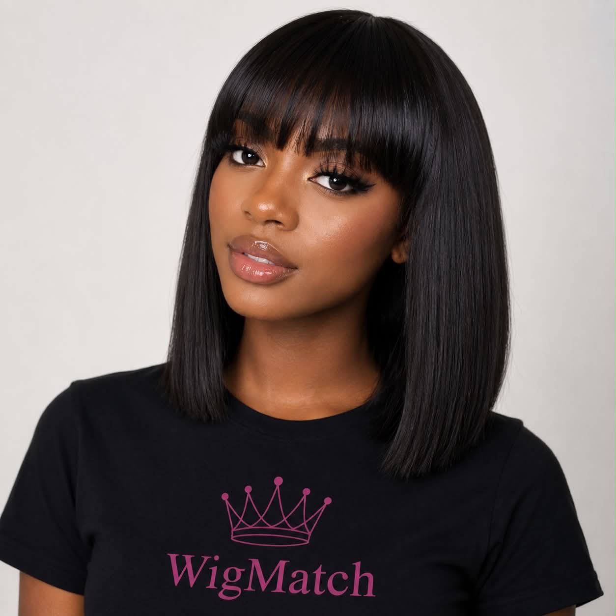 Natural black straight human hair bob wig with bangs featuring a sleek shoulder-length cut and soft natural shine by WigMatch.